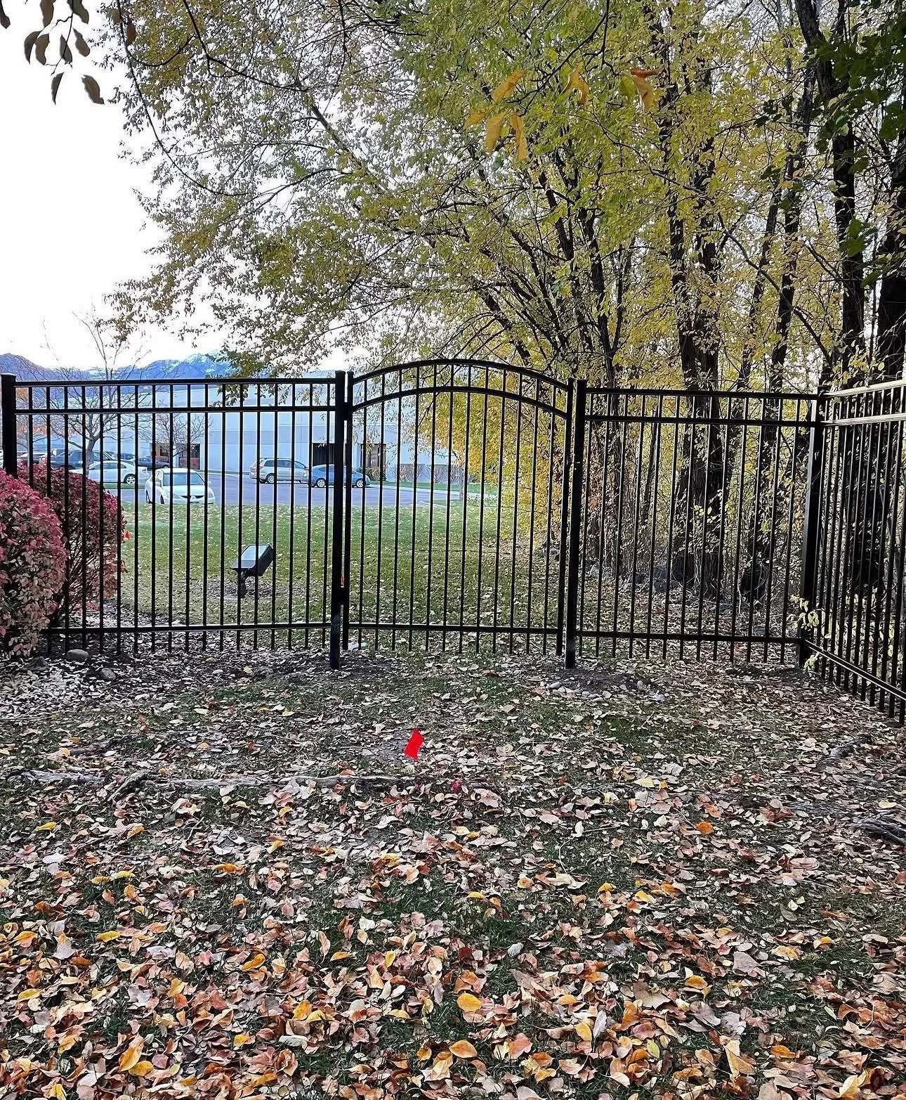 Black aluminum fence with an arched gate